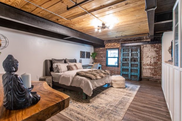 Main-floor bedroom looking toward the brick wall and antique doors