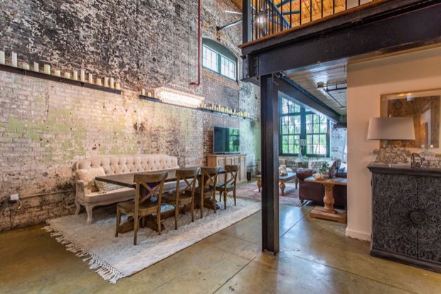 Dining area looking through to the kitchen, past a steel column and reclaimed wood wall