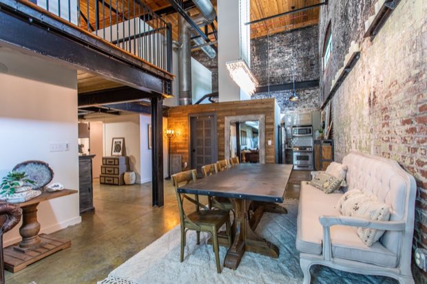 Dining and kitchen with polished concrete floors and the mezzanine overhead