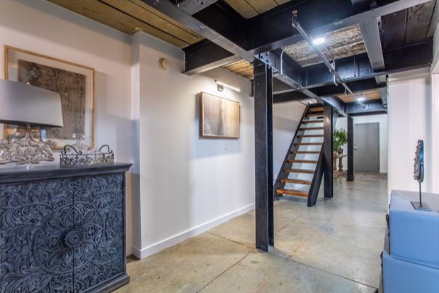 Entry hall with steel columns and the stair up to the mezzanine