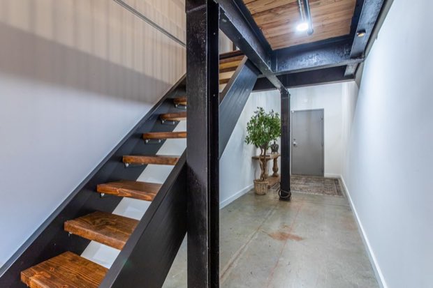 Open-tread stair beside the entry door