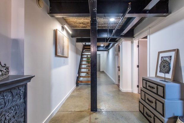 Hallway with the mezzanine stair and doors to the bedroom and laundry