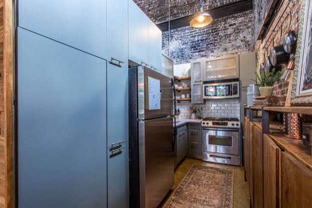 Galley kitchen looking toward the range, with full-height cabinetry