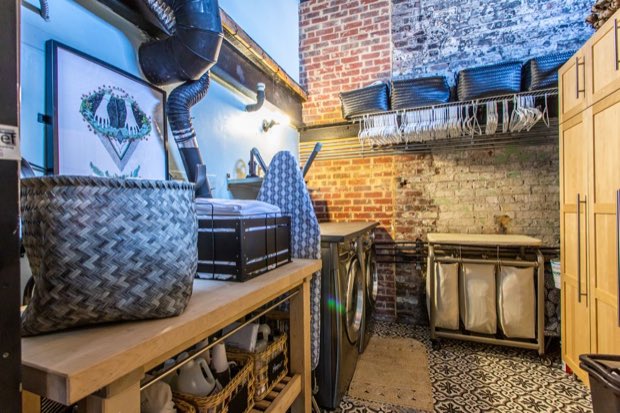 Laundry room with a full-size washer and dryer and patterned tile floor