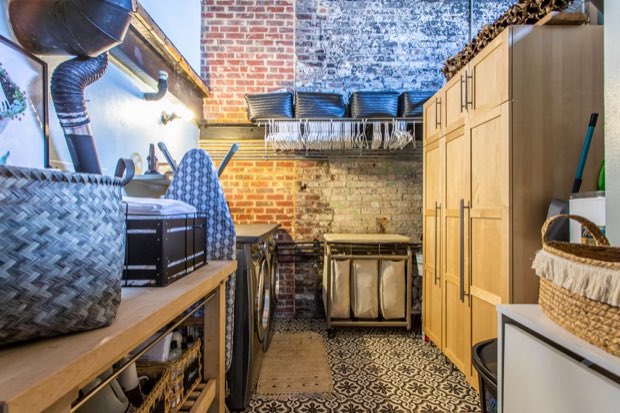 Laundry room with built-in storage and a hanging rack