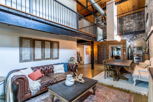 Living room beneath the mezzanine, looking through to the dining area and kitchen