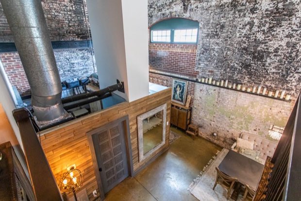 View down from the mezzanine to the entry and dining area