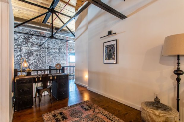 Mezzanine study with a campaign desk overlooking the main floor