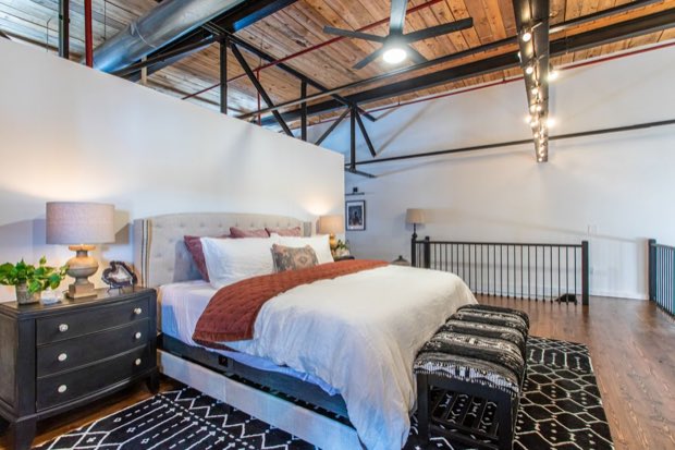 Loft bedroom looking out over the mezzanine railing