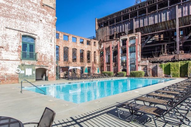 Community pool set within the preserved brick walls of the old mill