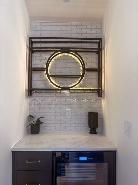 Coffee and wine bar with black open shelving, a backlit ring light and a built-in wine fridge