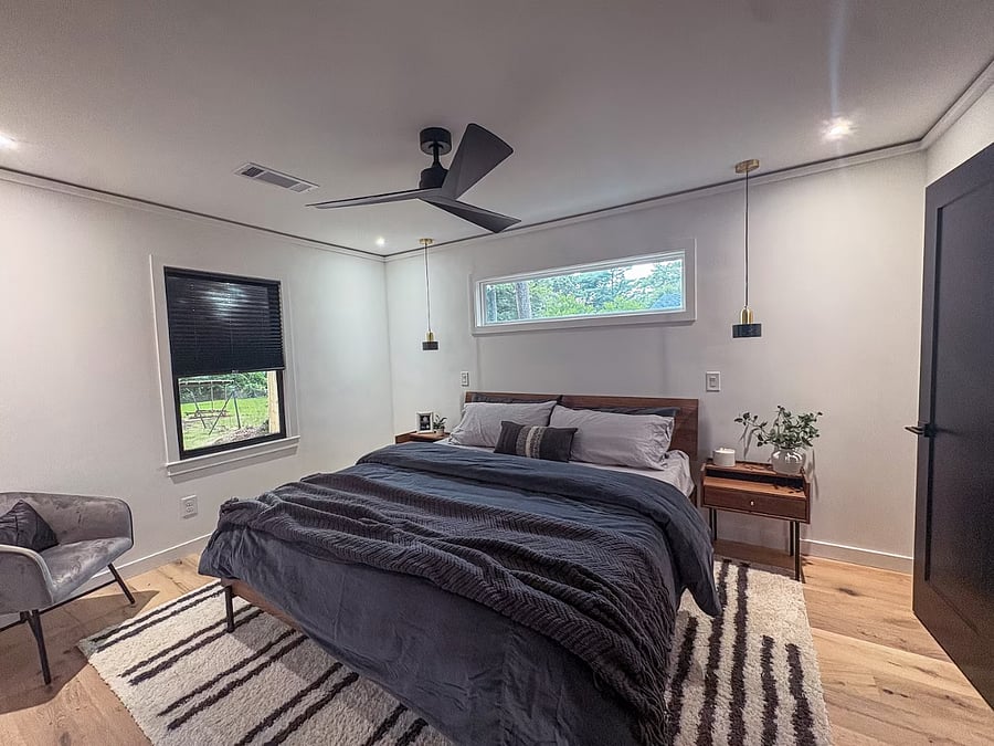 Primary bedroom with a ceiling fan, clerestory window and hanging bedside pendants