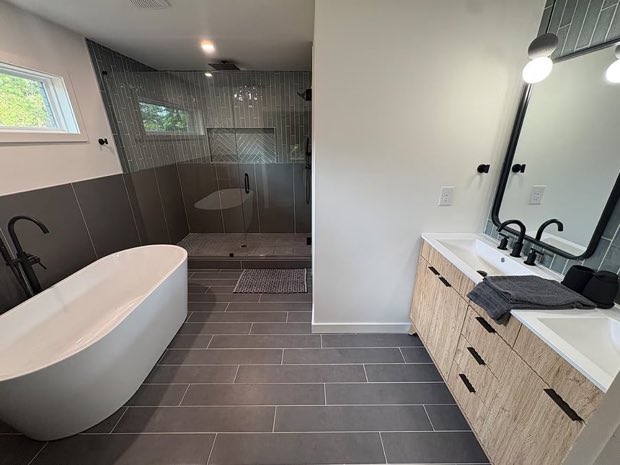 Primary bathroom with a freestanding tub, walk-in shower and wood double vanity