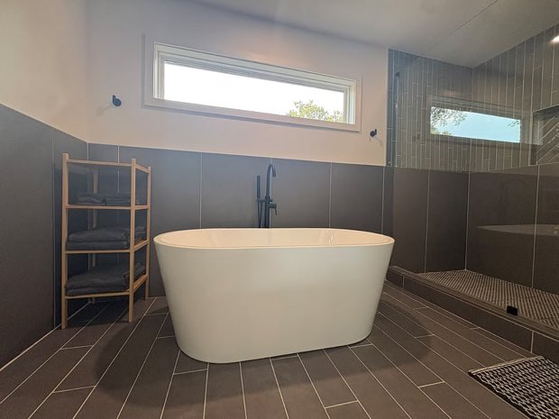 Freestanding soaking tub beside the walk-in shower