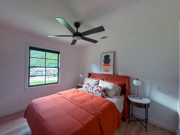 Second bedroom with a queen bed and ceiling fan