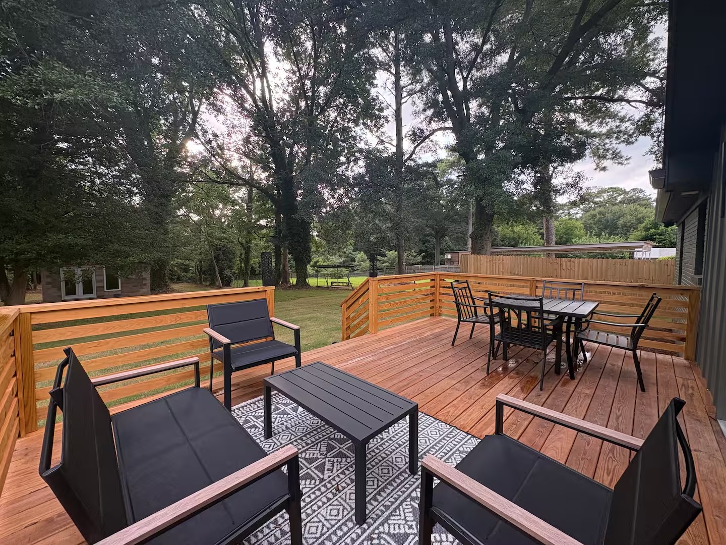 Large rear deck with lounge seating overlooking the yard