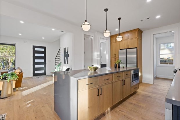 White oak kitchen island looking toward the entry and open stair