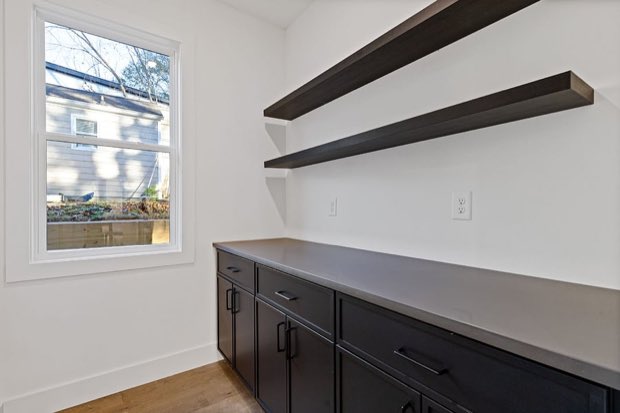 Butler's pantry with open shelving and prep counter