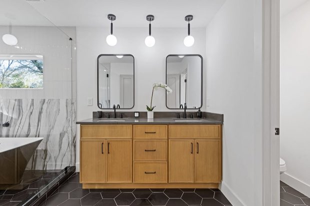 Primary bathroom double vanity with framed mirrors