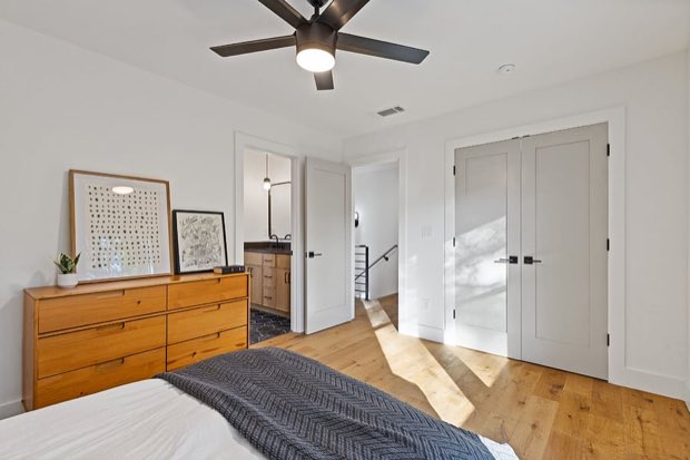 Bedroom with a wood dresser and ceiling fan