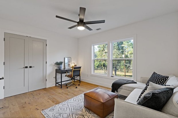 Flexible fourth bedroom, shown as a sitting room with a sofa and desk