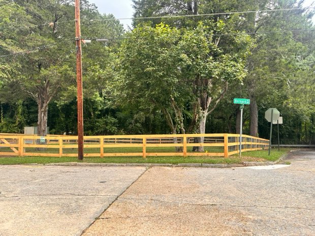 The corner of Bernard Road NW, with the fenced community green space across the street